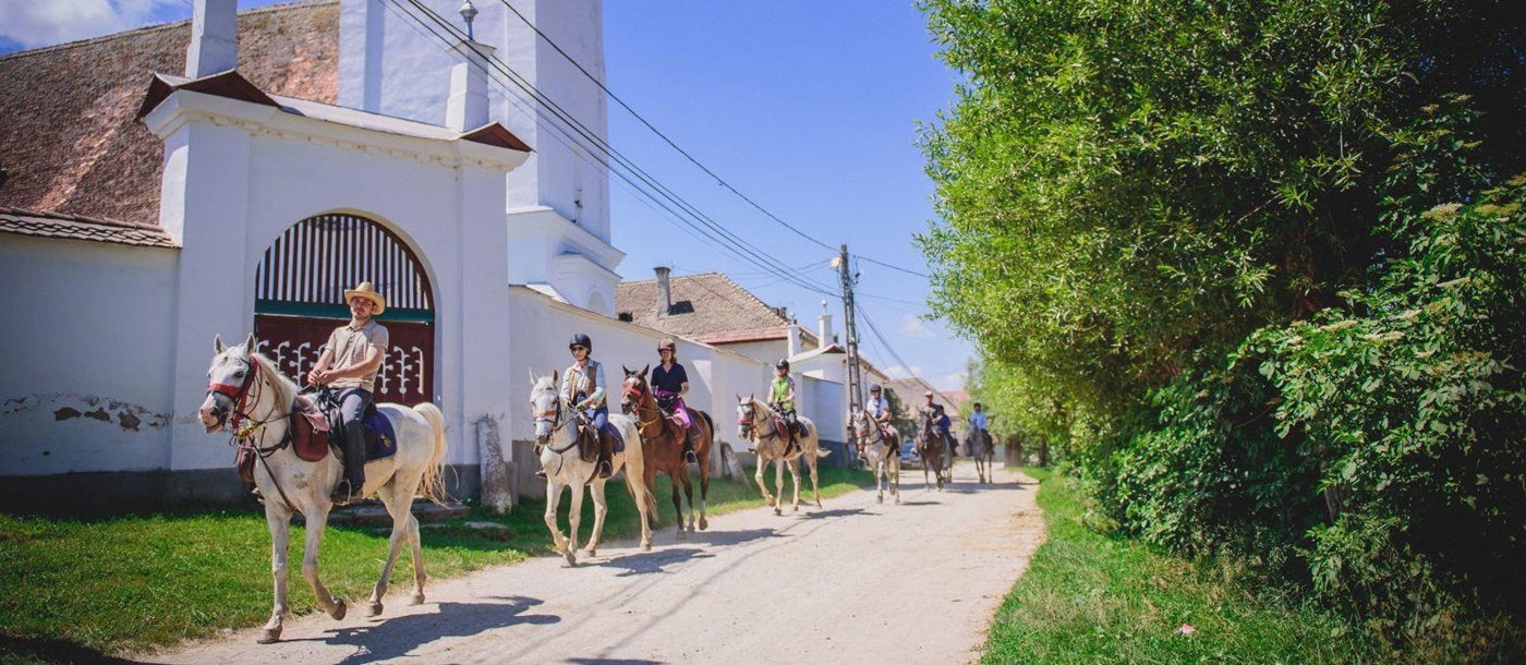 Horse riding through traditional villages in Transylvania, Romania