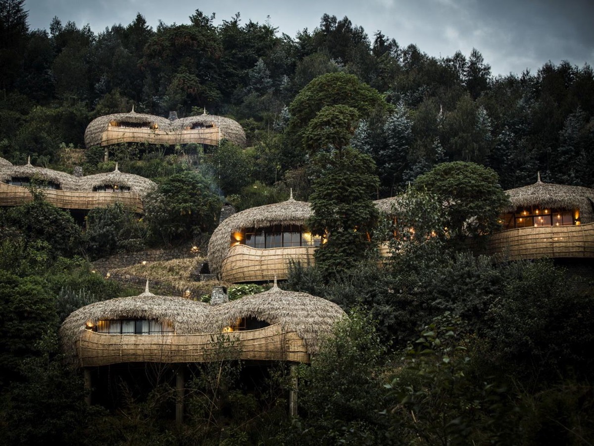 A view of the exterior of thatched bamboo villas set in the hillside at Bisate Lodge in Rwanda