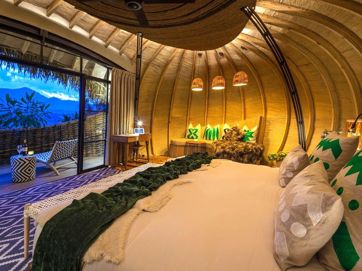 Guest room at dusk at Wilderness Bisate Lodge in Rwanda