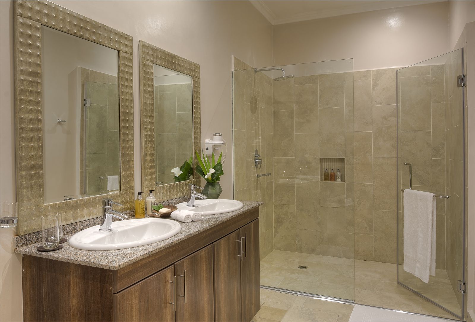 Luxury en-suite bathroom at The Bishops House hotel in Rwanda with large walk in shower, two sinks and two mirrors