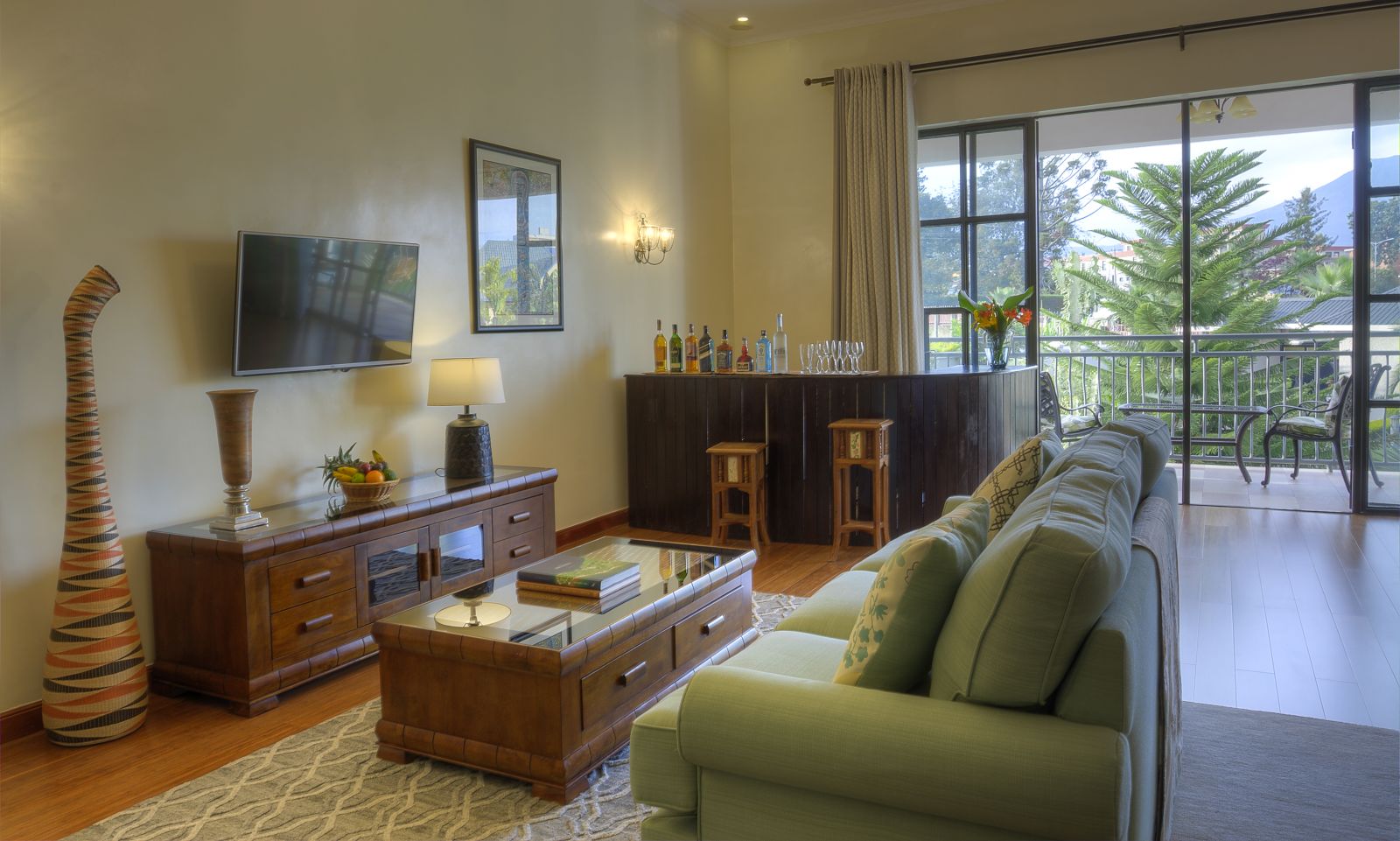 The living area with an outside balcony in a bedroom suite at The Bishops House hotel in Rwanda 