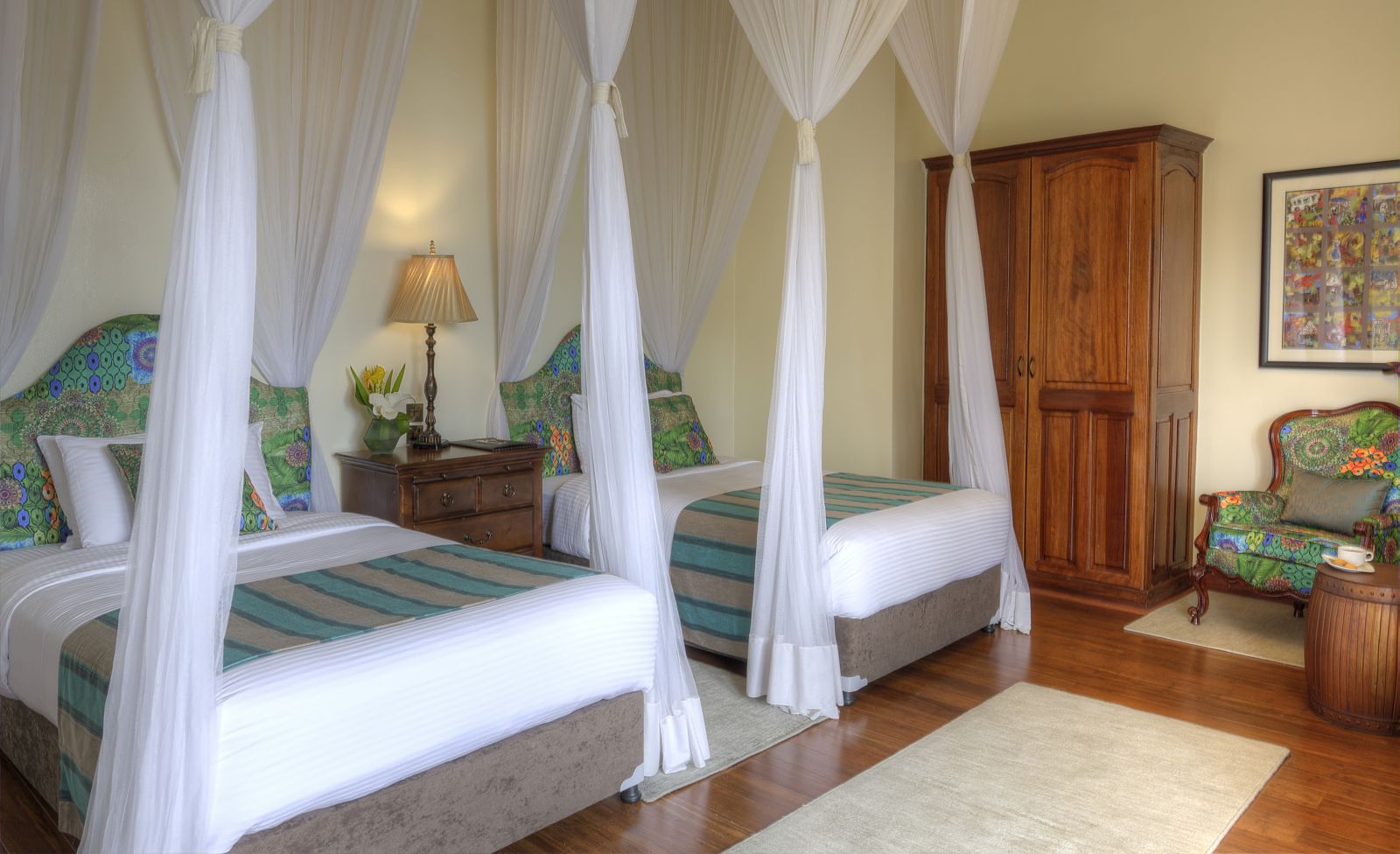 A twin bedroom at The Bishops House hotel in Rwanda with two large single beds a wardrobe and chair