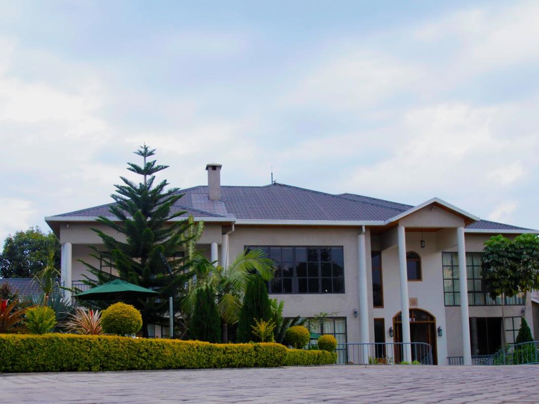 The exterior of The Bishops House hotel in Rwanda with gardens to the left hand side