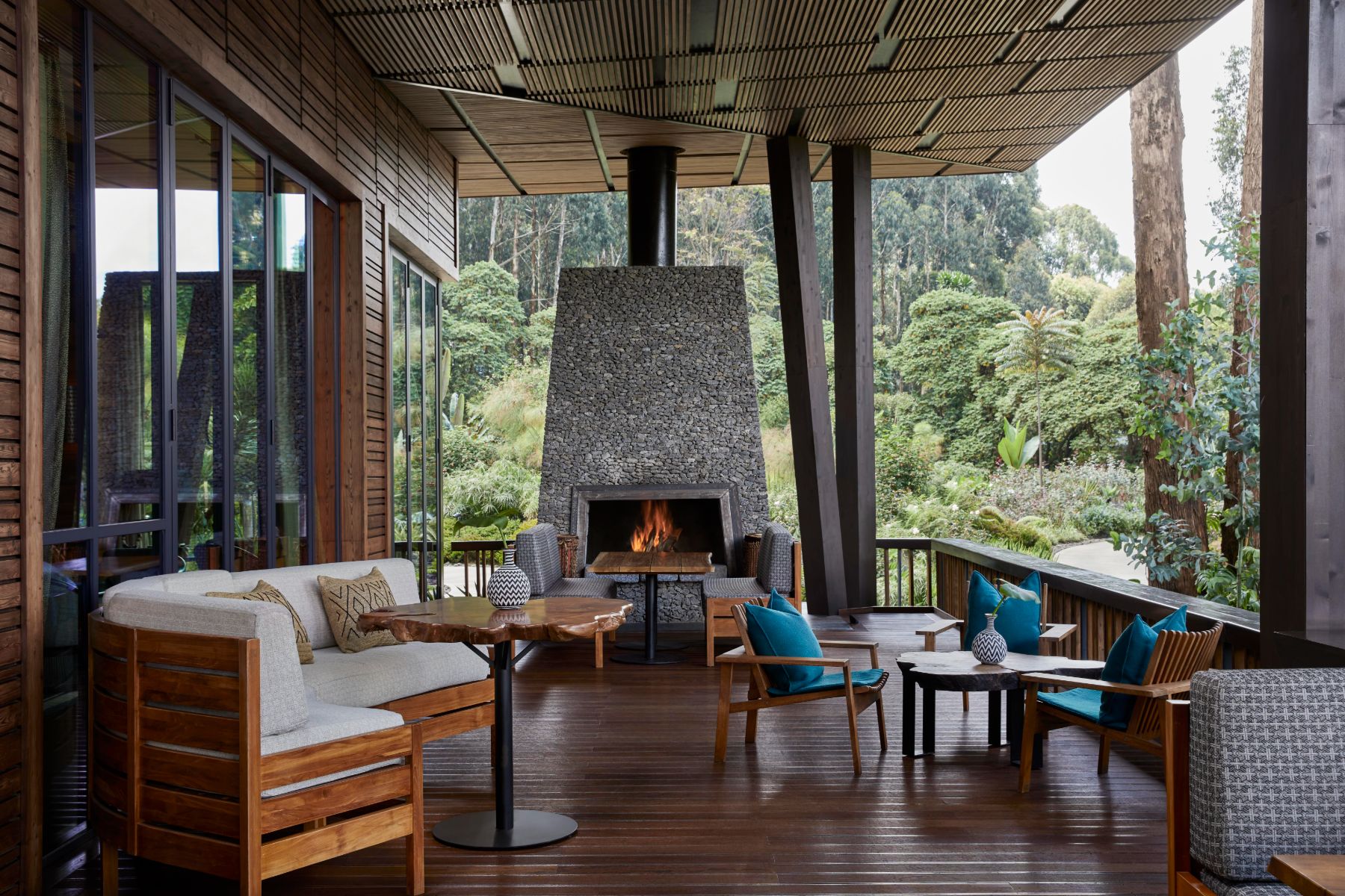 Lounge with fireplace at The Nest bar at One&Only Gorilla's Nest in Rwanda's Volcanoes National Park