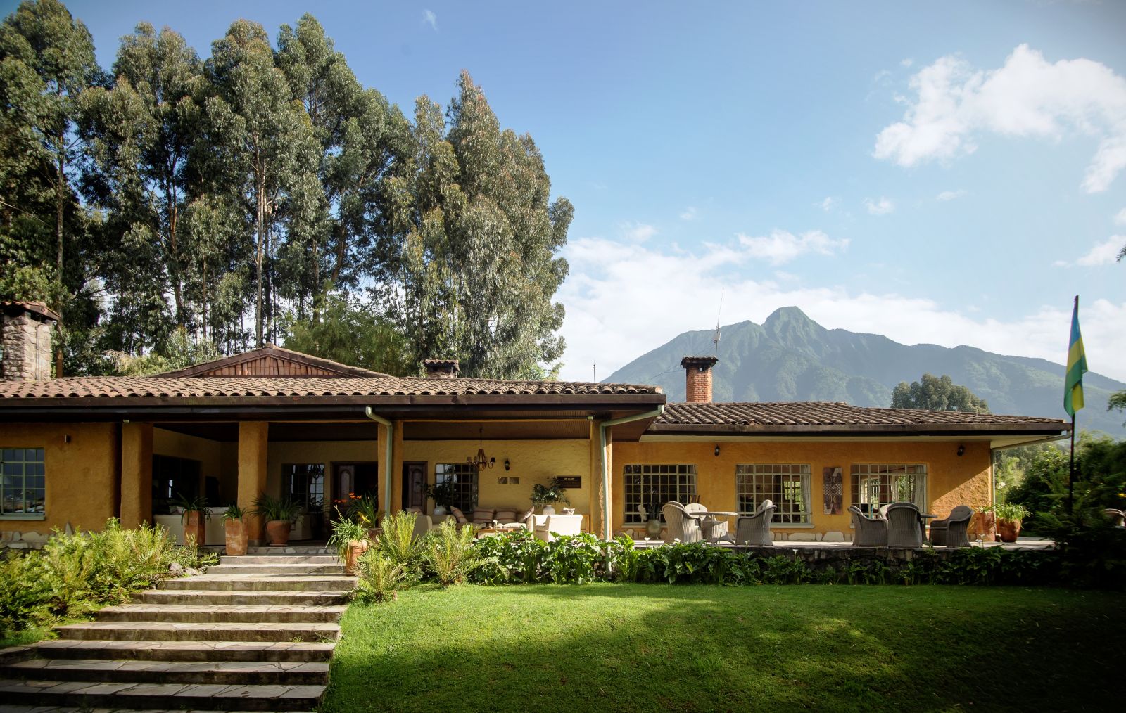 The exterior view of Sabyinyo Silverback Lodge in Rwanda with the mountains in the background