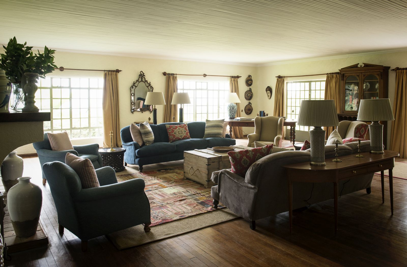 A large sitting room with a selection of sofas, chairs and tables at Sabyinyo Silverback Lodge in Rwanda