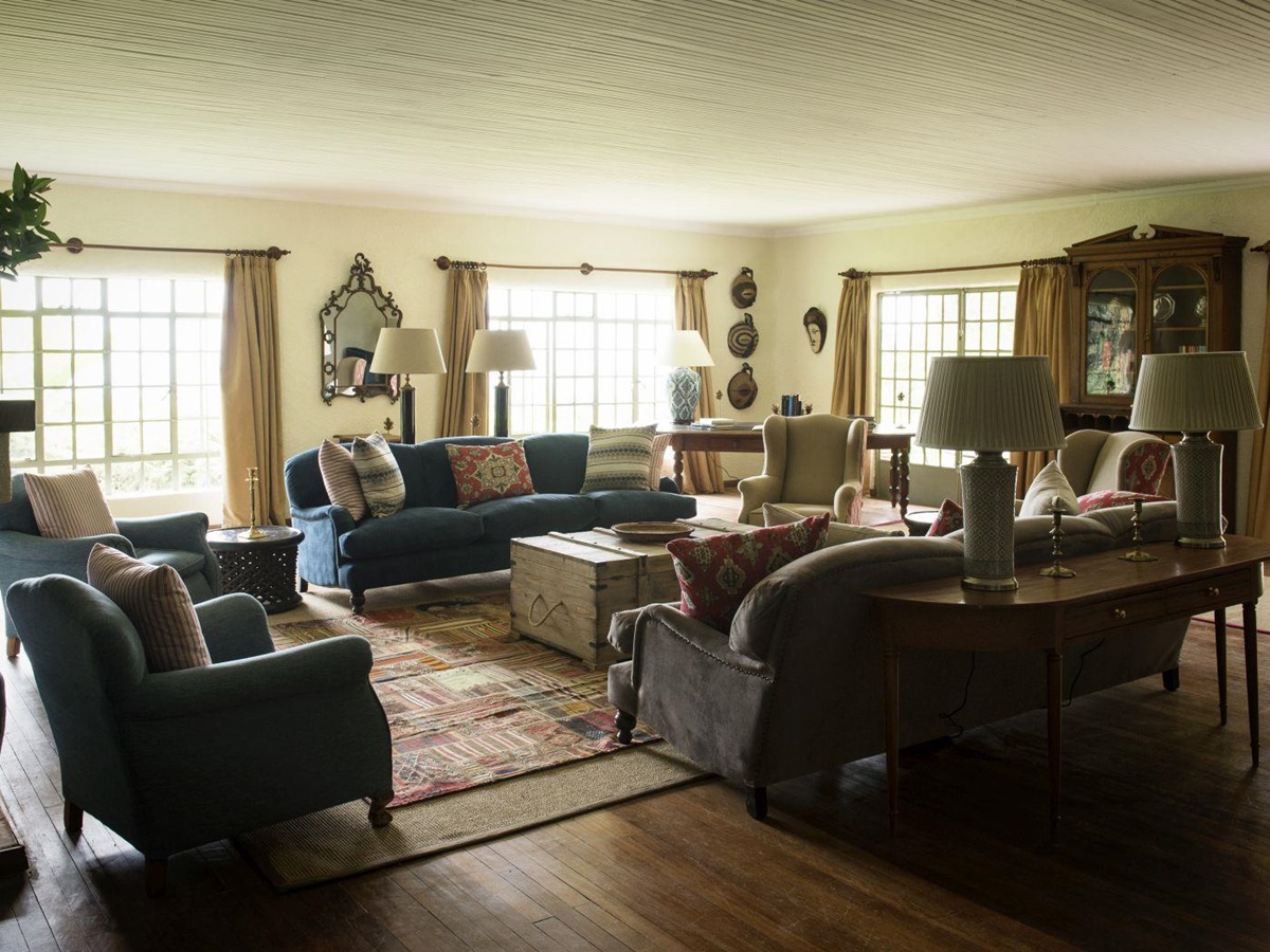 A large sitting room with a selection of sofas, chairs and tables at Sabyinyo Silverback Lodge in Rwanda