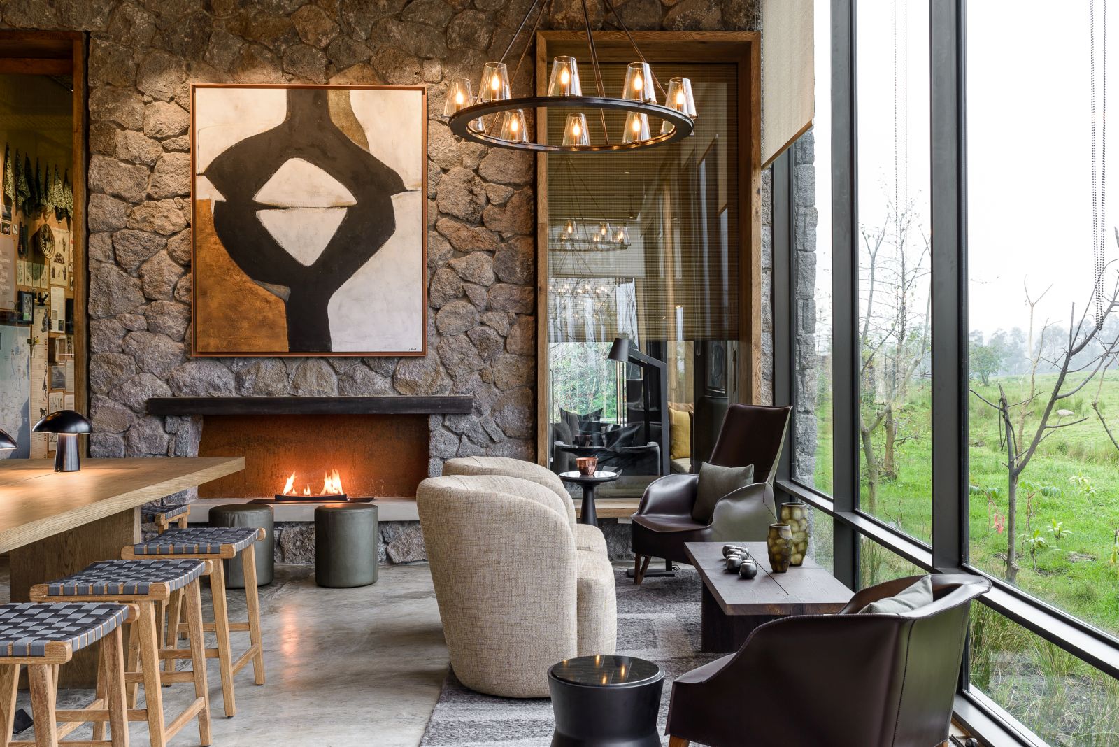 Sitting room with fireplace at Singita Kwitonda Lodge in Rwanda