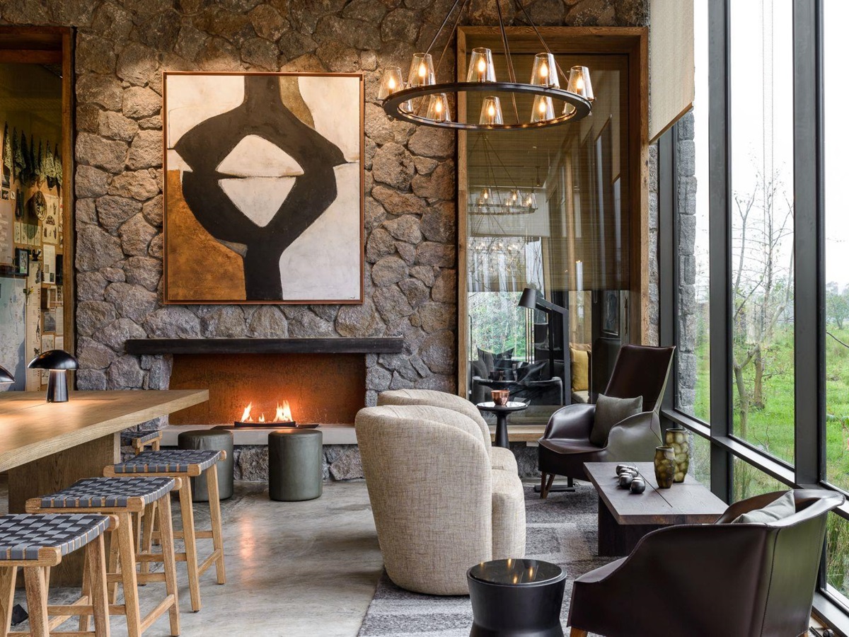 Sitting room with fireplace at Singita Kwitonda Lodge in Rwanda