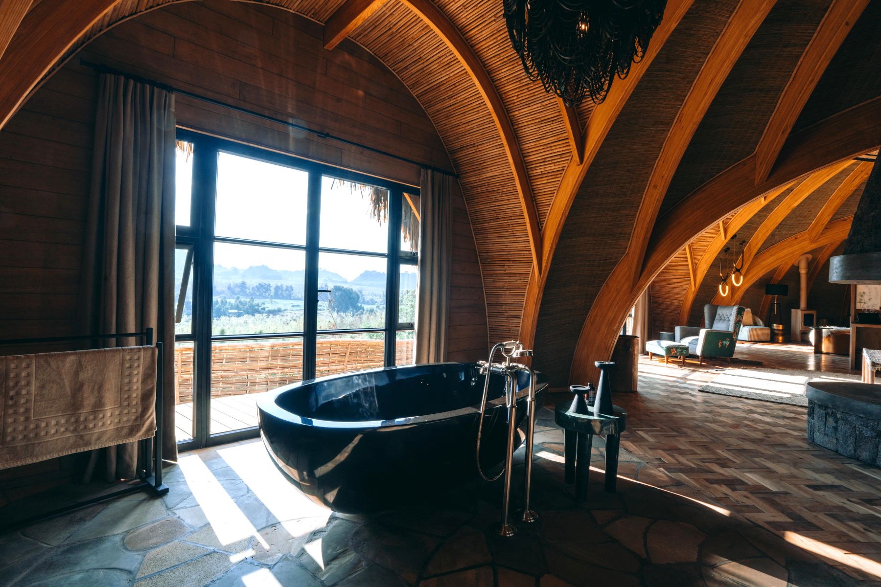 Freestanding black bath tub in a suite at Wilderness Bisate Reserve Rwanda