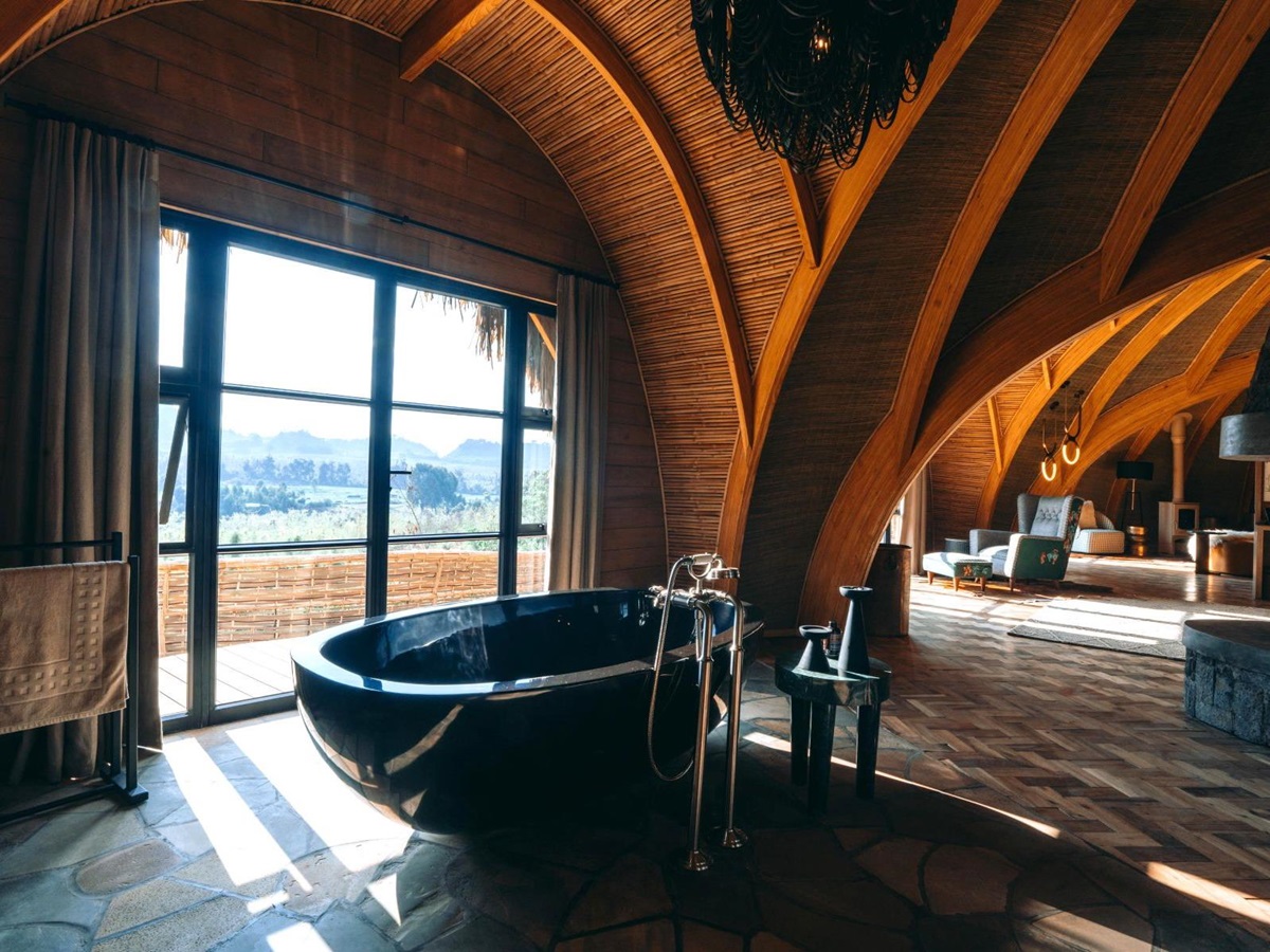 Freestanding black bath tub in a suite at Wilderness Bisate Reserve Rwanda