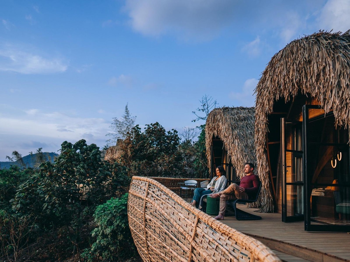 Couple sitting on the terrace of a suite at Wilderness Bisate Reserve Rwanda