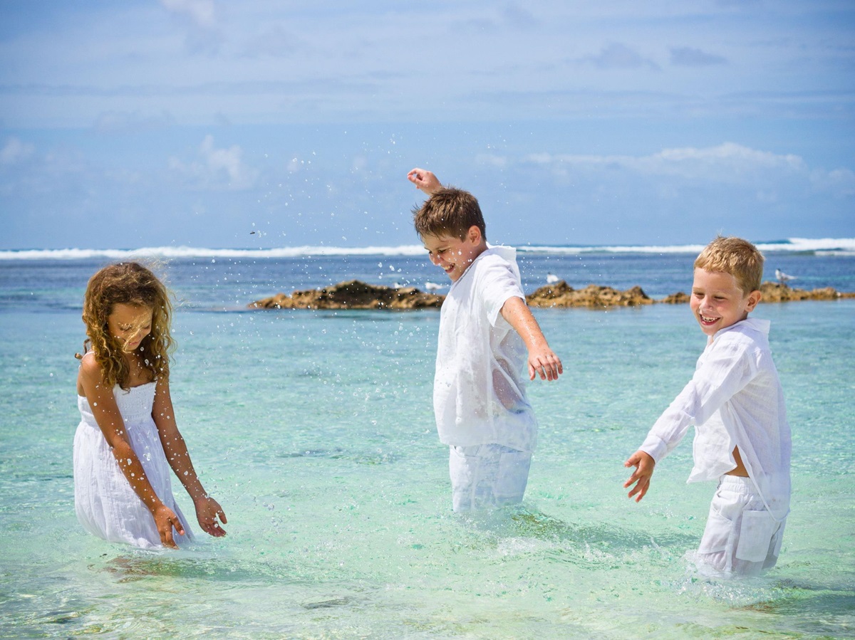 Children playing in the ocean at Denis Island, Seychelles