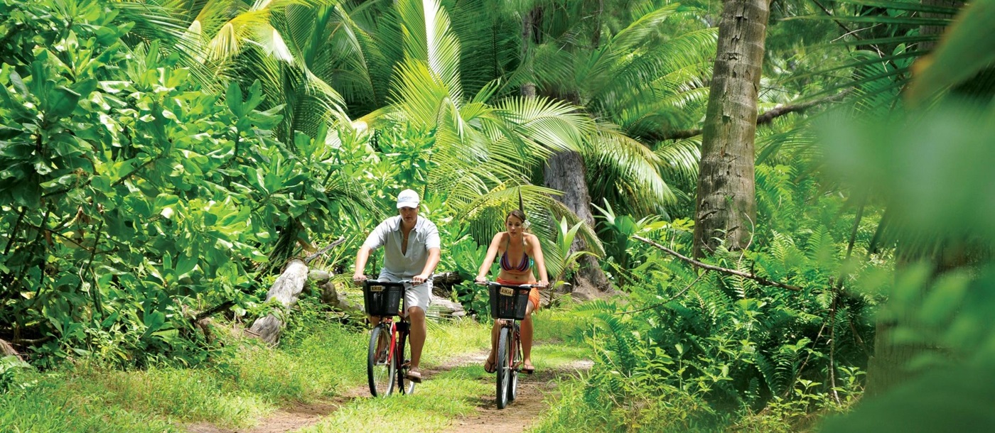 Two bikers in the jungle at Desroches, Seychelles
