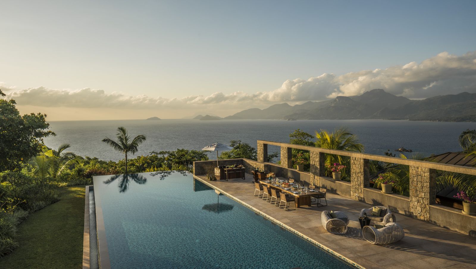 A dining table by the poolside at Four Seasons Seychelles