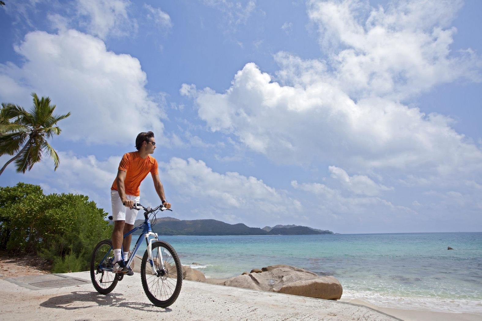 Biking on the shores near Raffles, Praslin, Seychelles