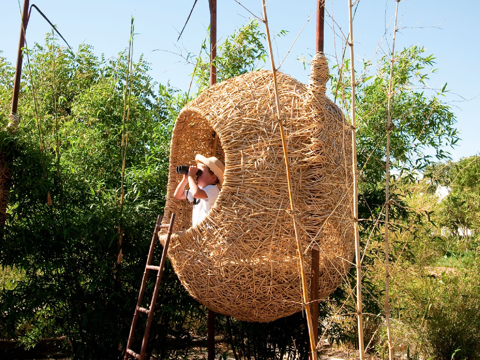 Child in cocoon playhouse at Babylonstoren in South Africa