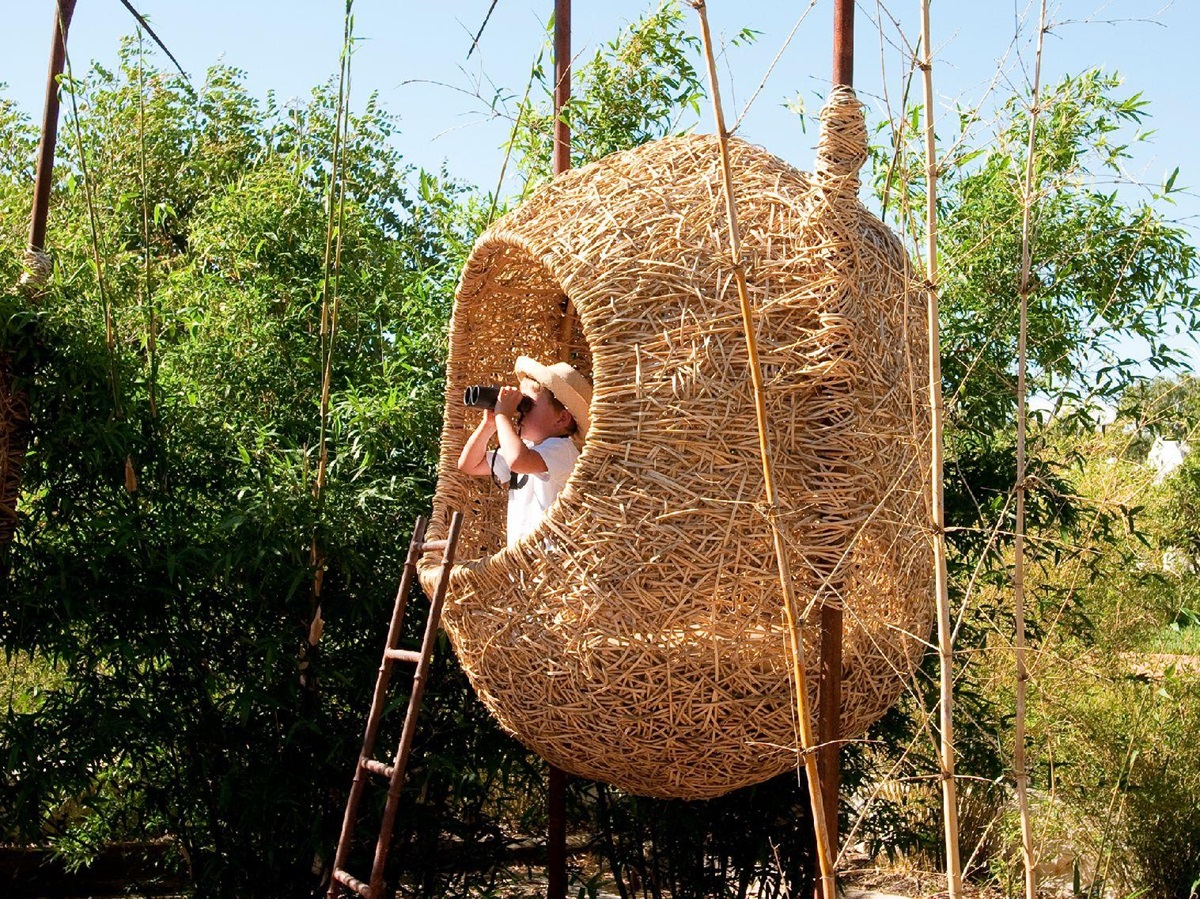 Child in cocoon playhouse at Babylonstoren in South Africa