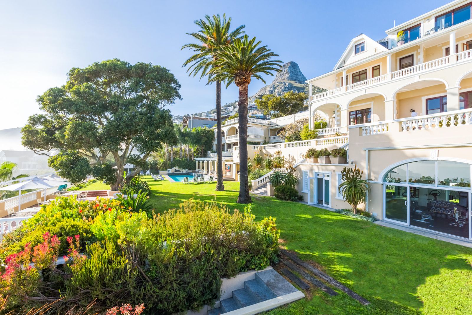 Exterior gardens with lion head statue at luxury hotel Ellerman House in Cape Town South Africa