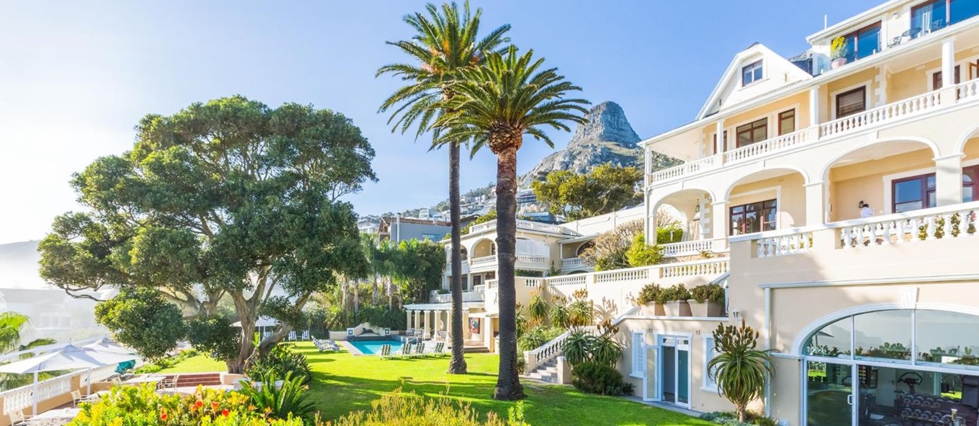 Exterior gardens with lion head statue at luxury hotel Ellerman House in Cape Town South Africa