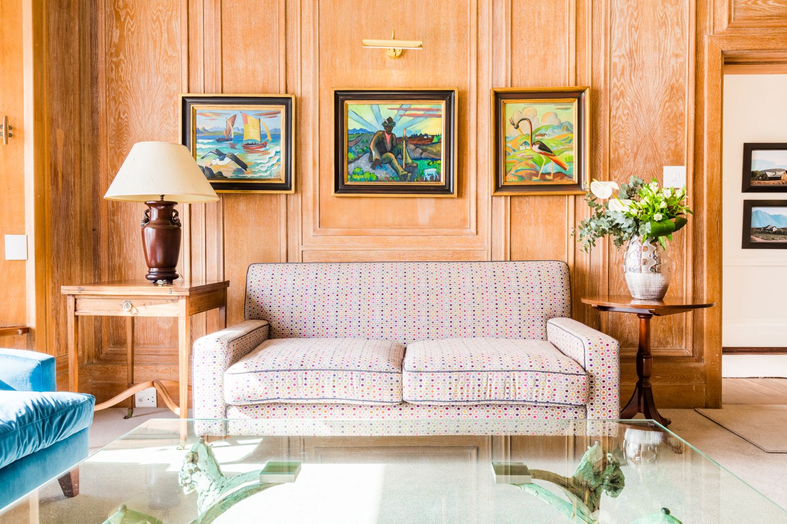 Couch framed by local artwork at luxury hotel Ellerman House in Cape Town