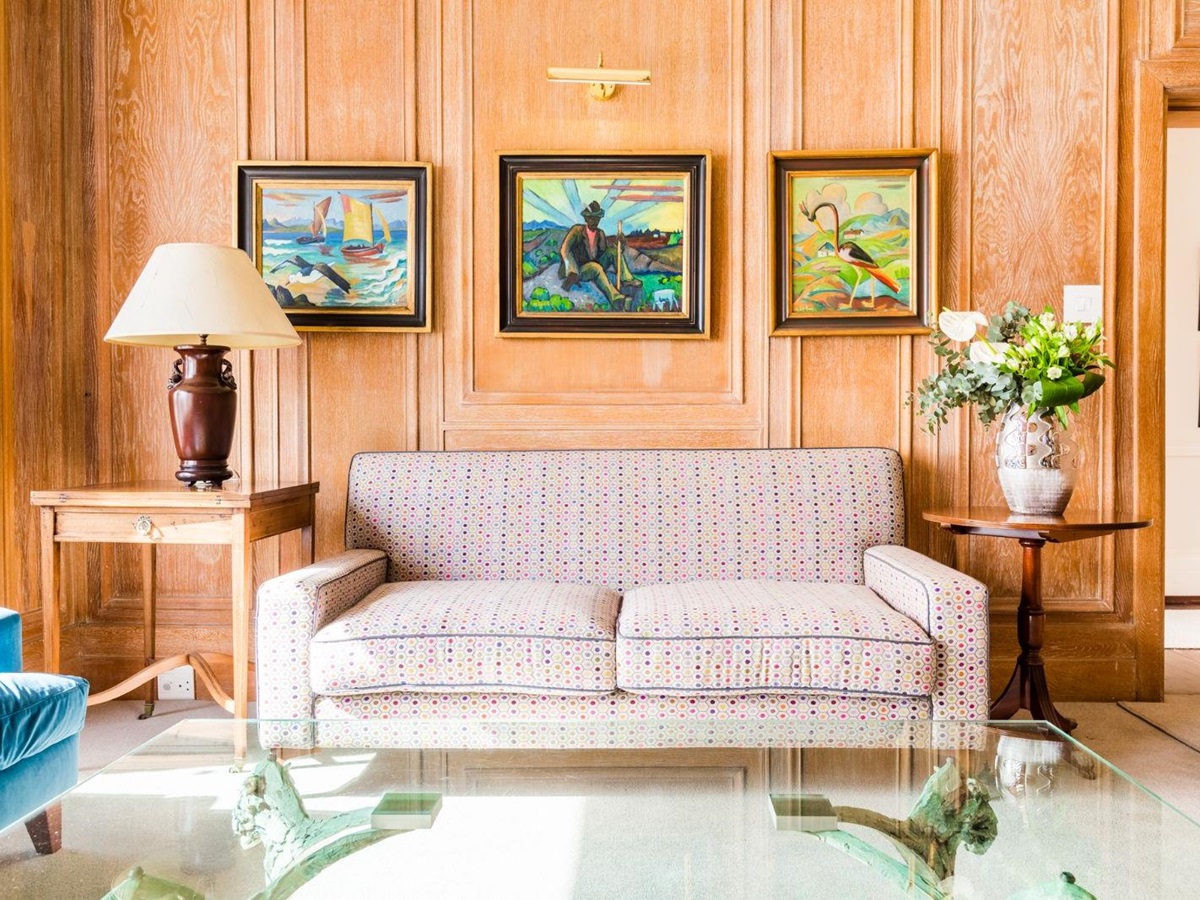 Couch framed by local artwork at luxury hotel Ellerman House in Cape Town