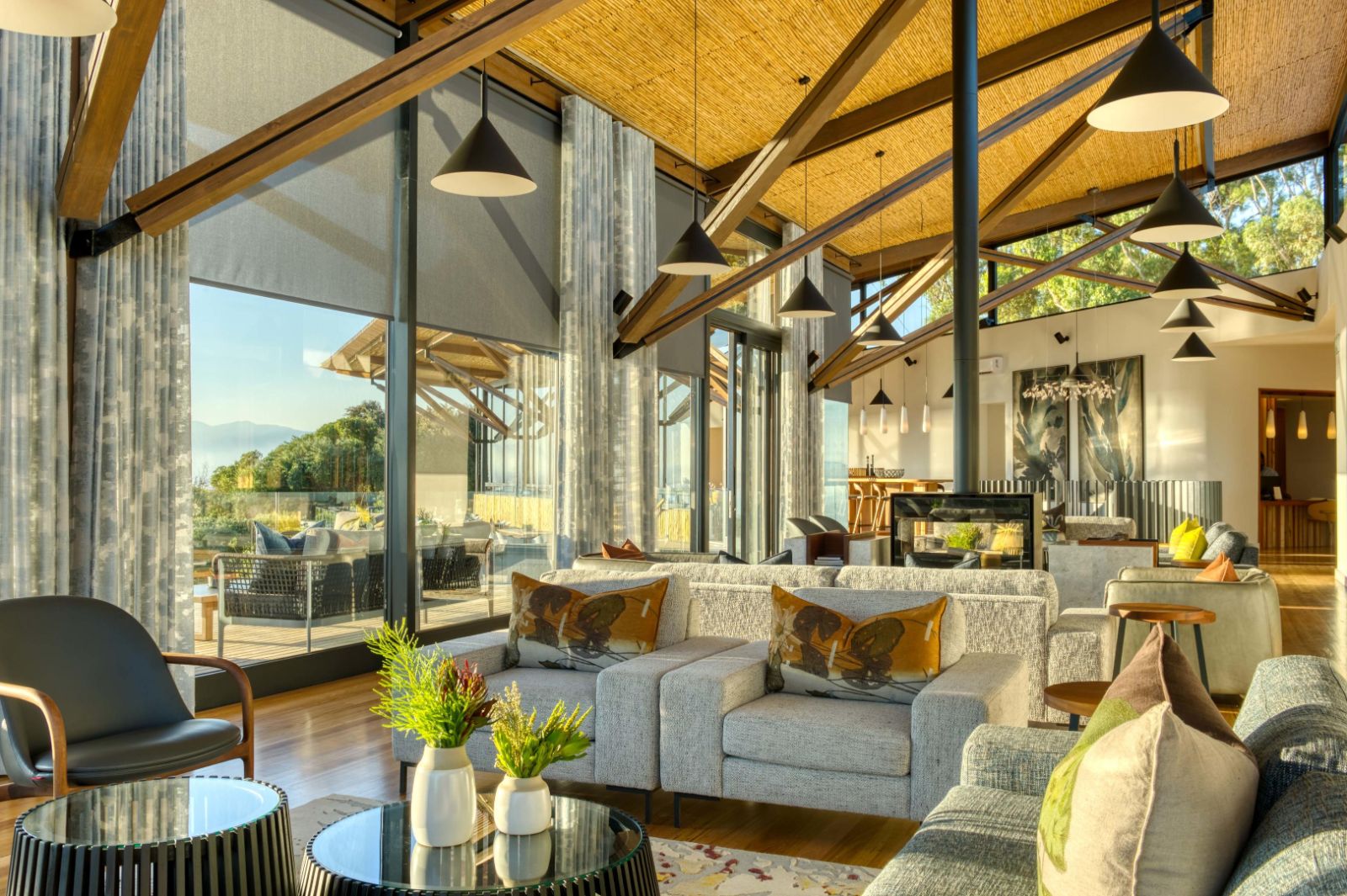 Bright and spacious indoor lounge area with wooden beams at luxury lodge Grootbos Garden Lodge in South Africa