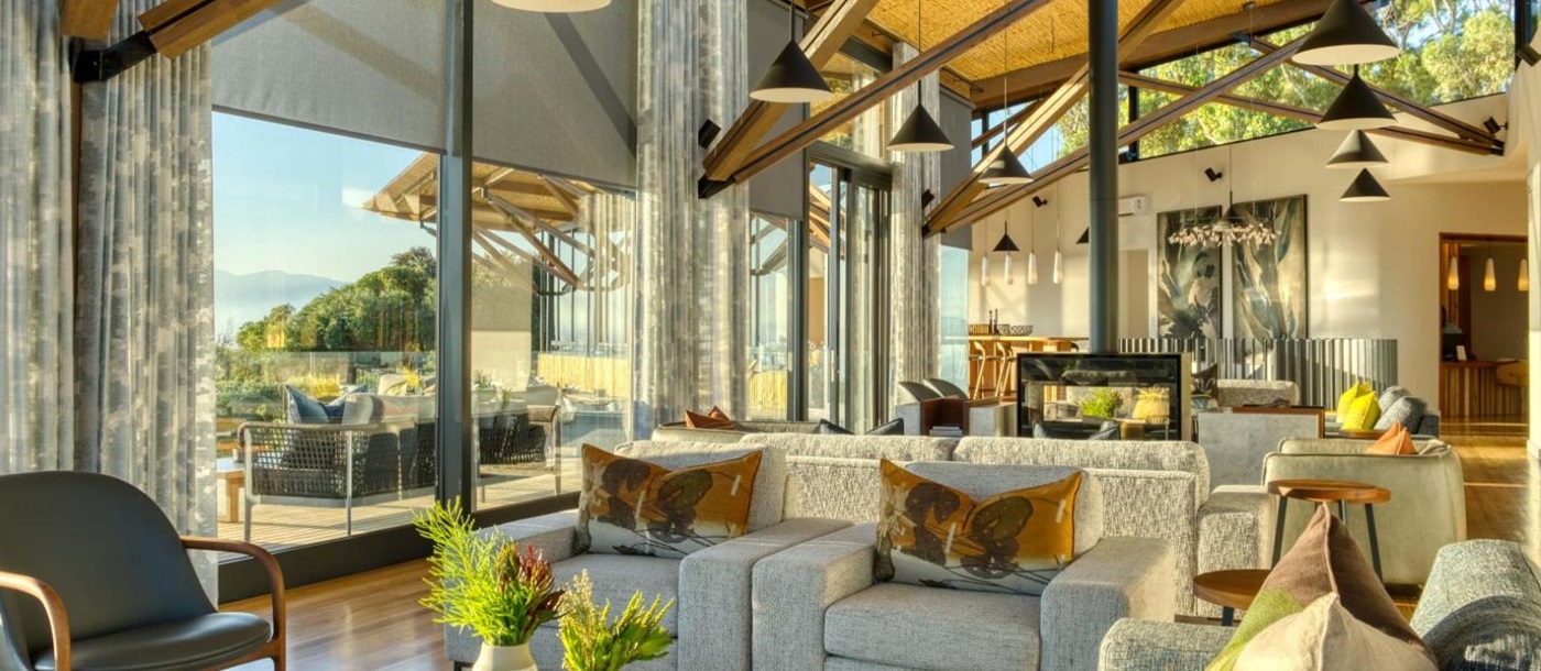 Bright and spacious indoor lounge area with wooden beams at luxury lodge Grootbos Garden Lodge in South Africa
