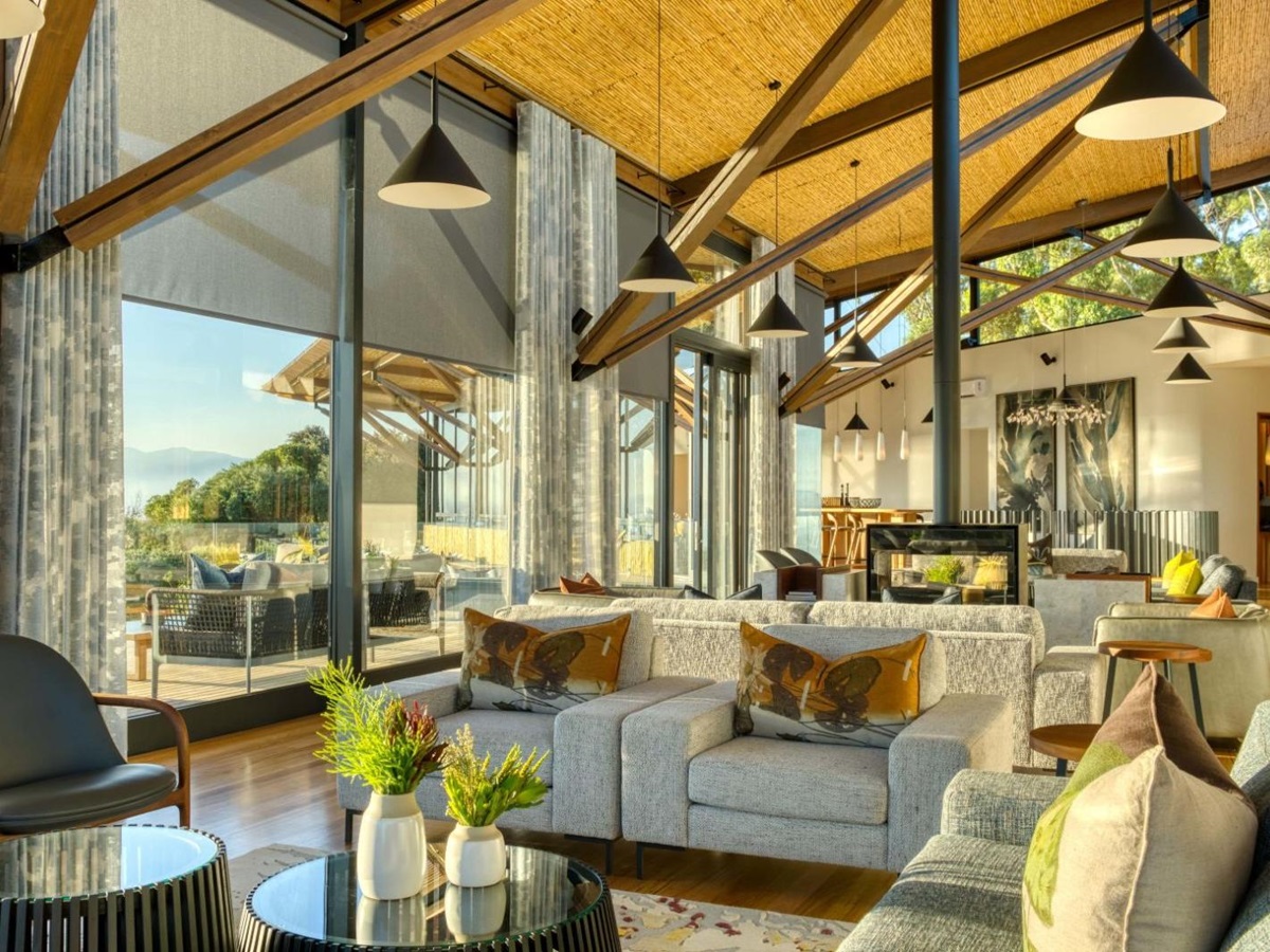 Bright and spacious indoor lounge area with wooden beams at luxury lodge Grootbos Garden Lodge in South Africa