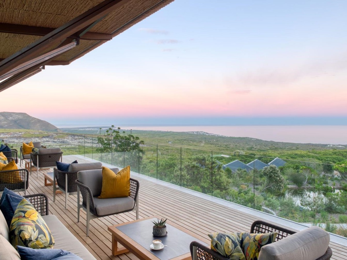 Outside lounge terrace with panoramic views of the coastline at luxury lodge Grootbos Garden Lodge in South Africa