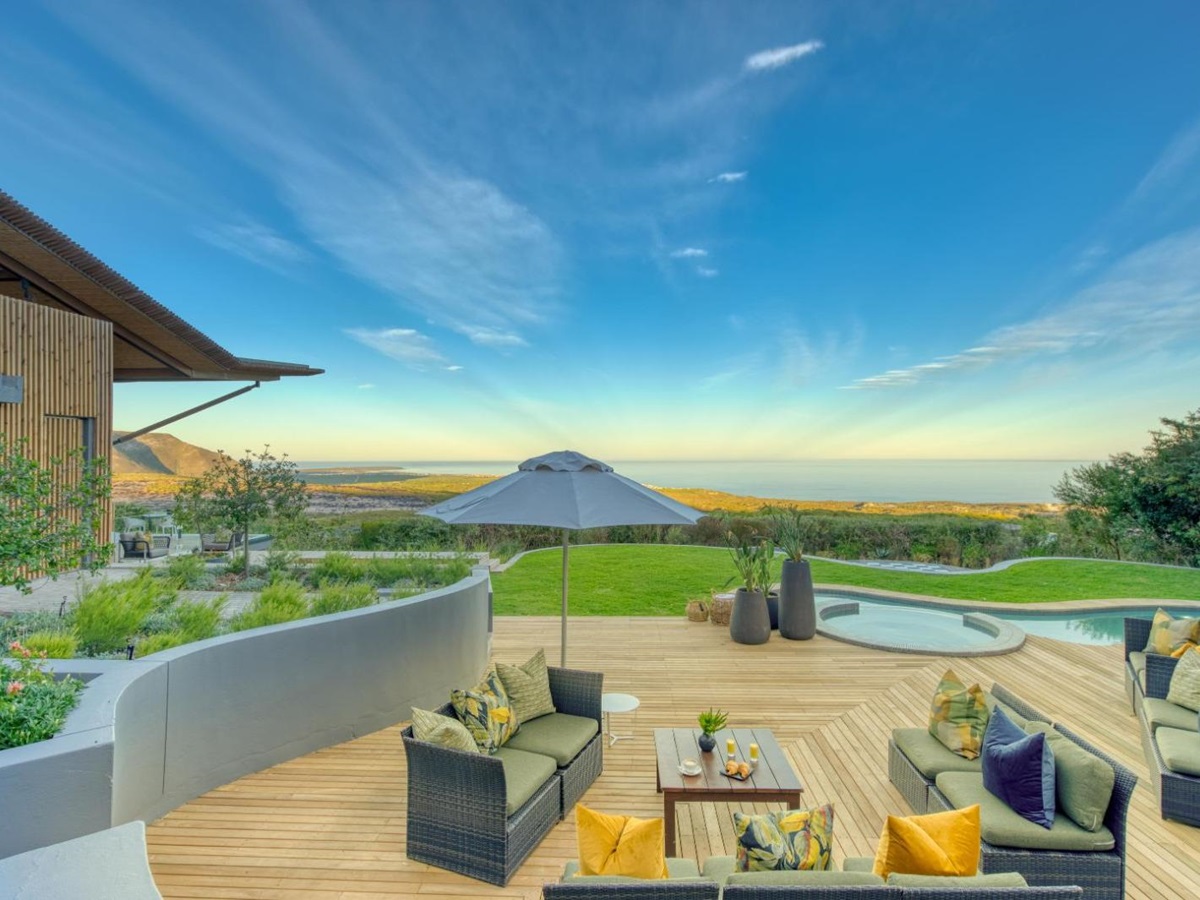 Outdoor lounge area with sofas by the pool at luxury lodge Grootbos Garden Lodge in South Africa