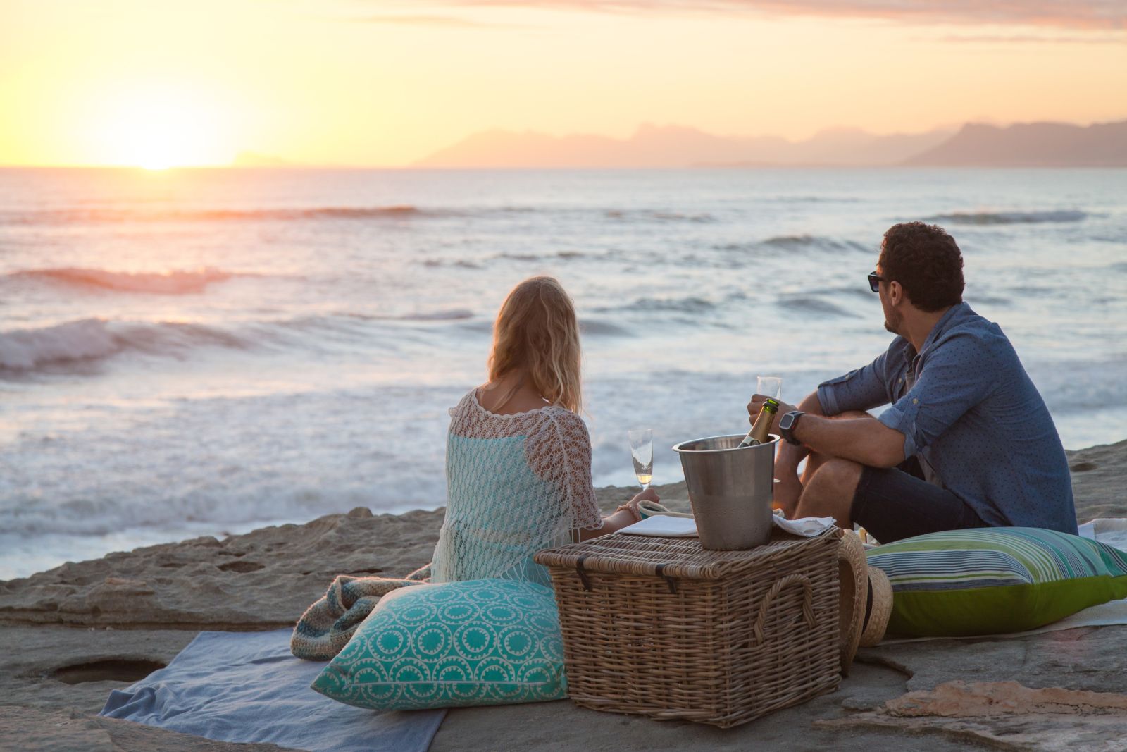Couple enjoying a sunset beach picnic at Grootbos Private Reserve South Africa