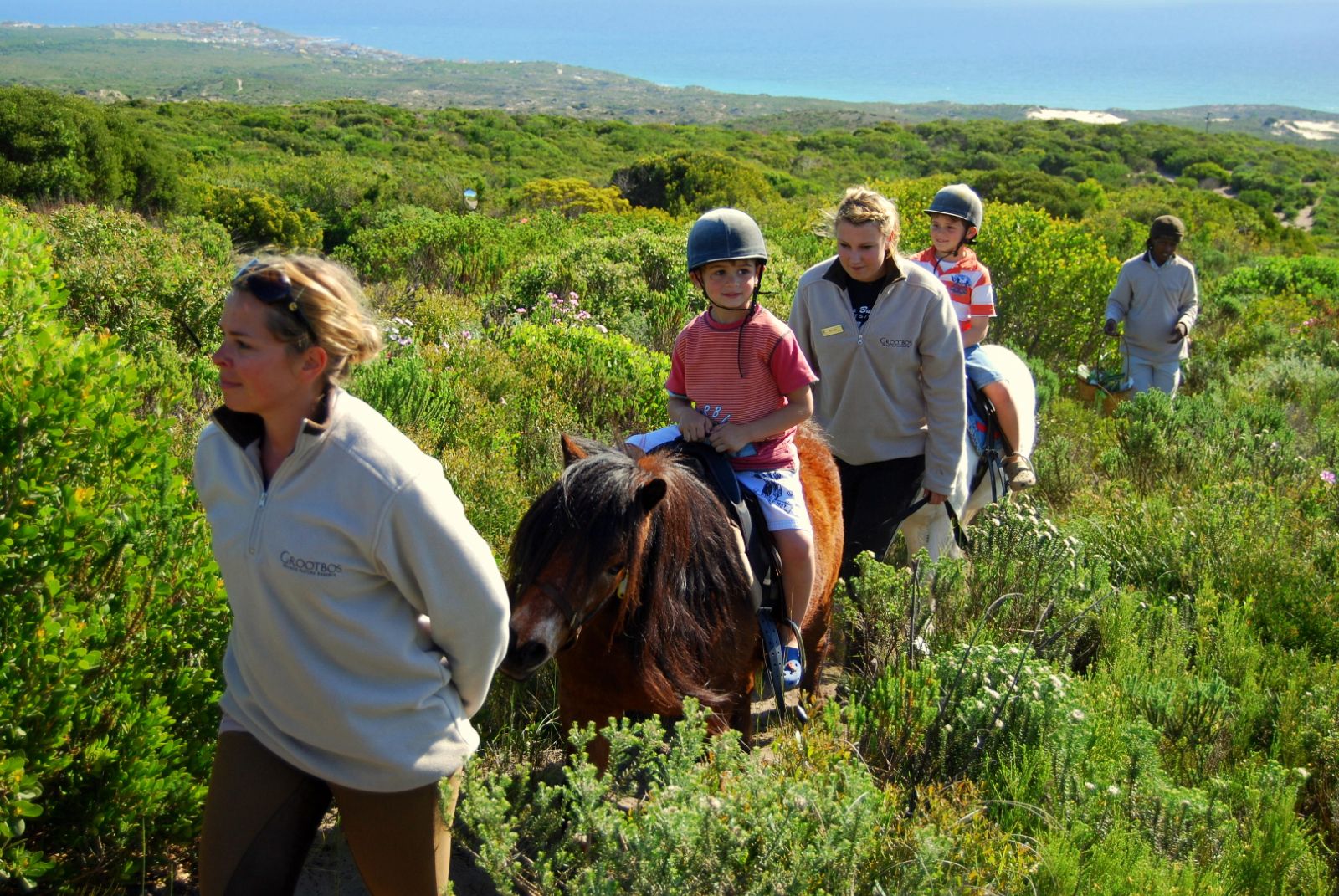 Children enjoying a pony ride at the Grootbos private reserve in South Africa
