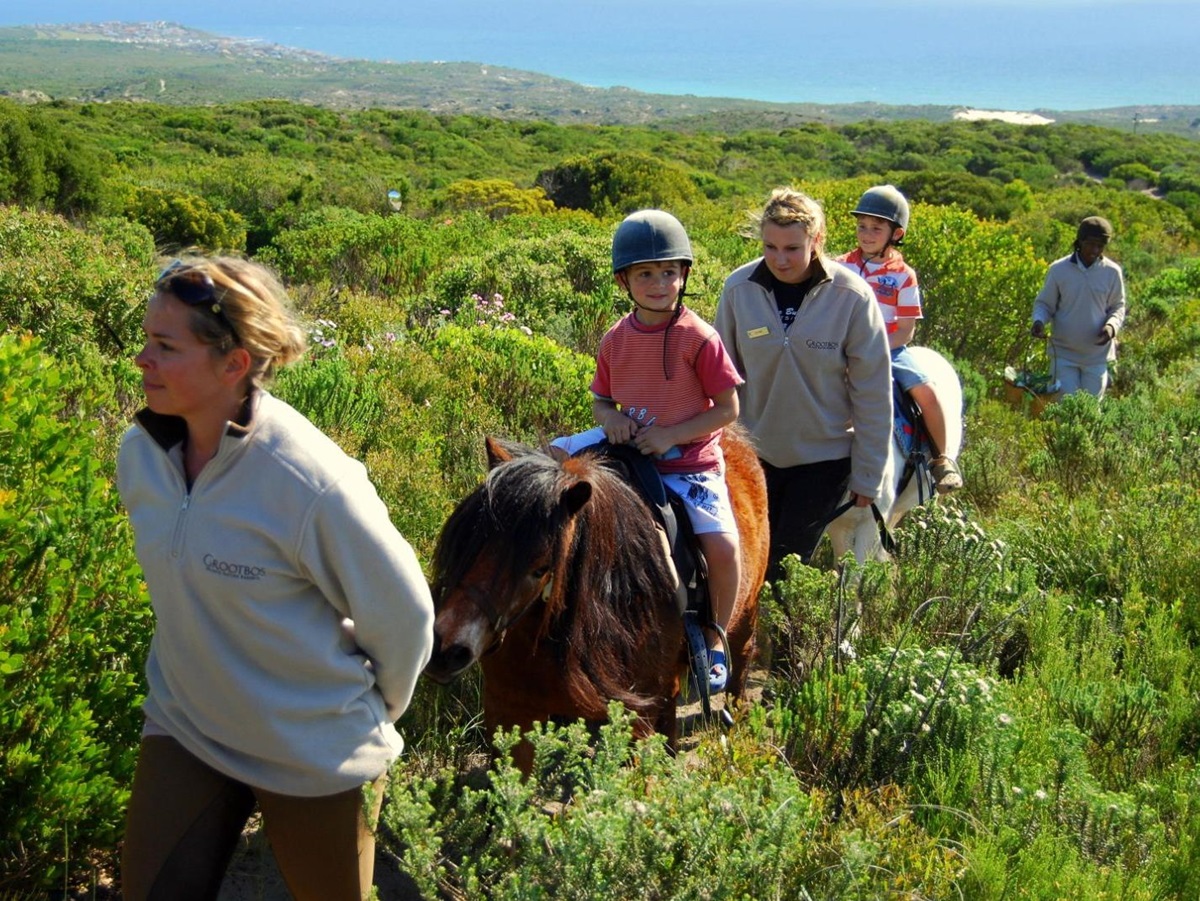 Children enjoying a pony ride at the Grootbos private reserve in South Africa