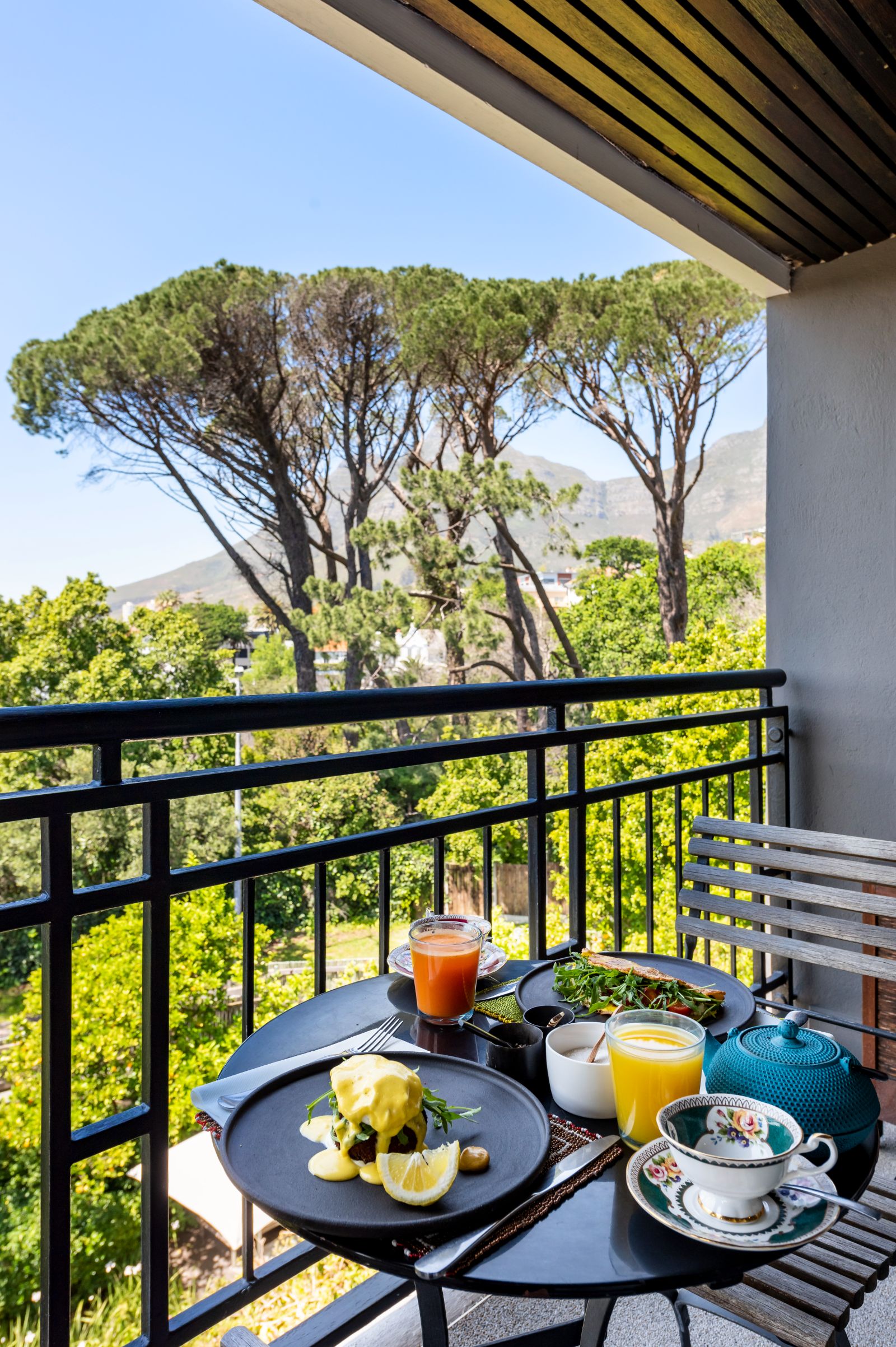 African tea and breakfast on superior room balcony with views of Table Mountain at luxury hotel Kensington Place in Cape Town South Africa