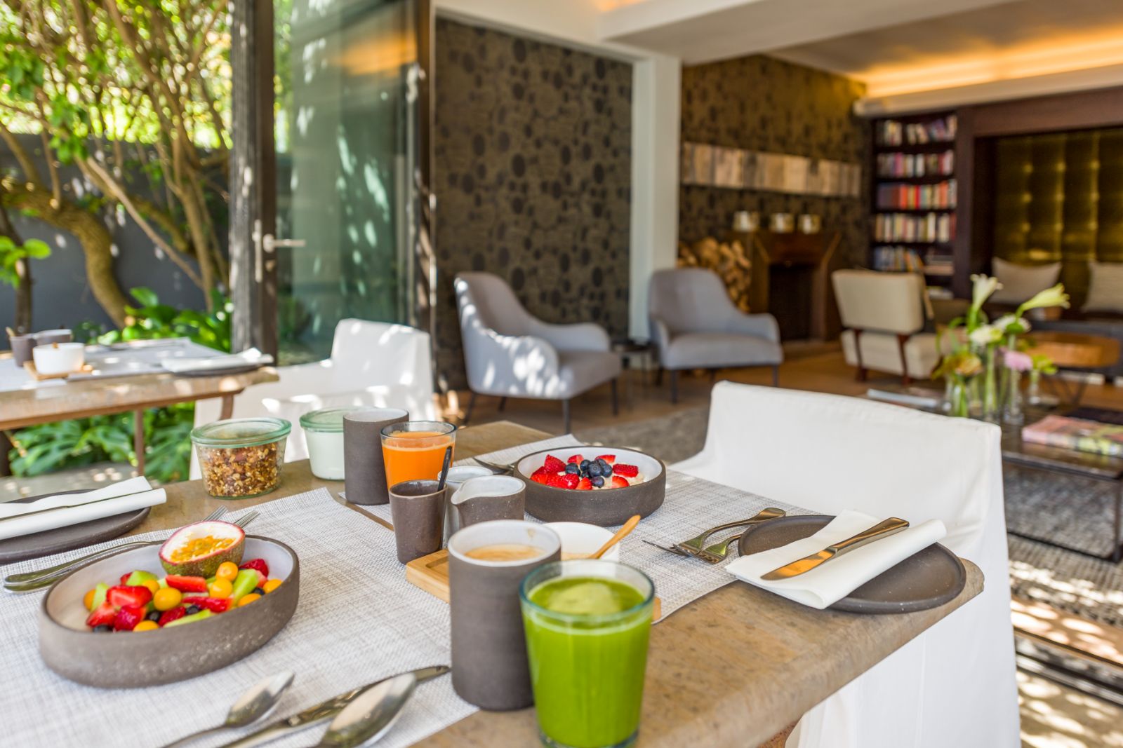 Fruit and smoothie breakfast on dining terrace of superior room at luxury hotel Kensington Place in Cape Town South Africa