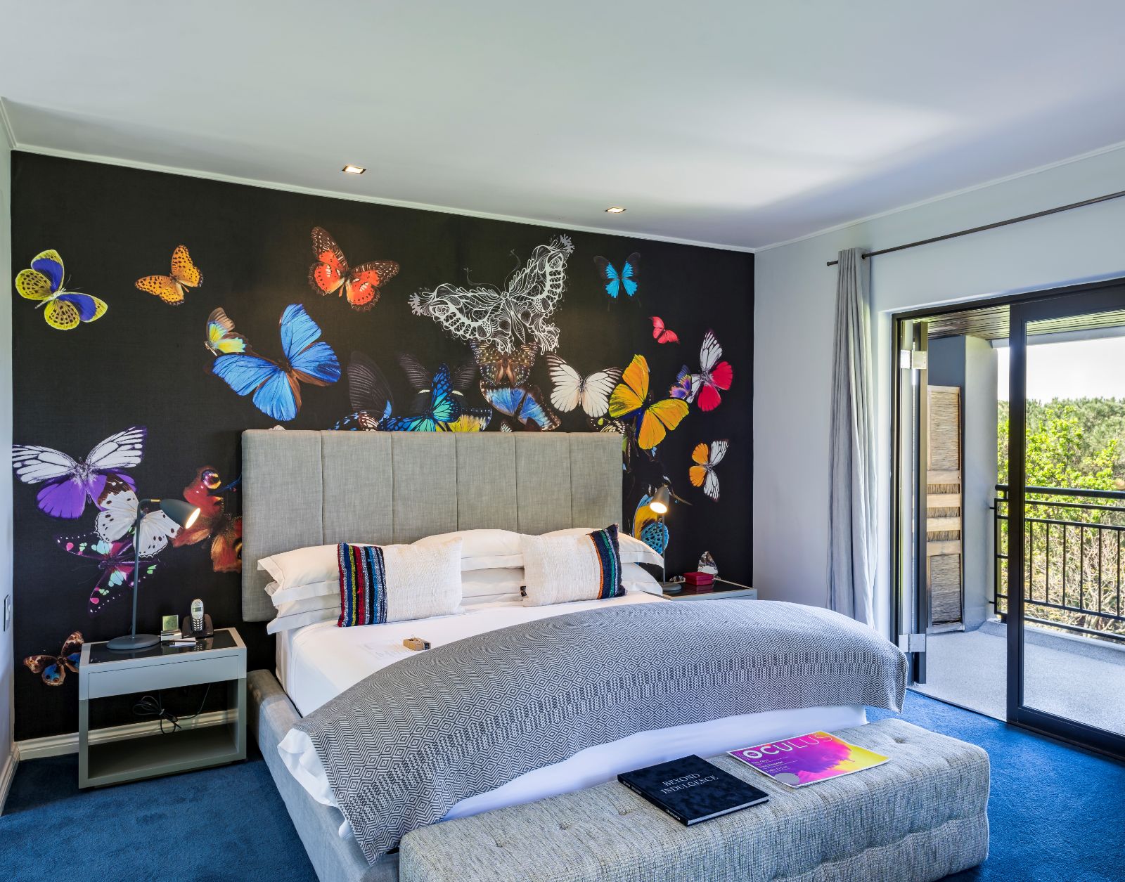 Superior room with butterfly wallpaper and balcony at luxury hotel Kensington Place in Cape Town South Africa