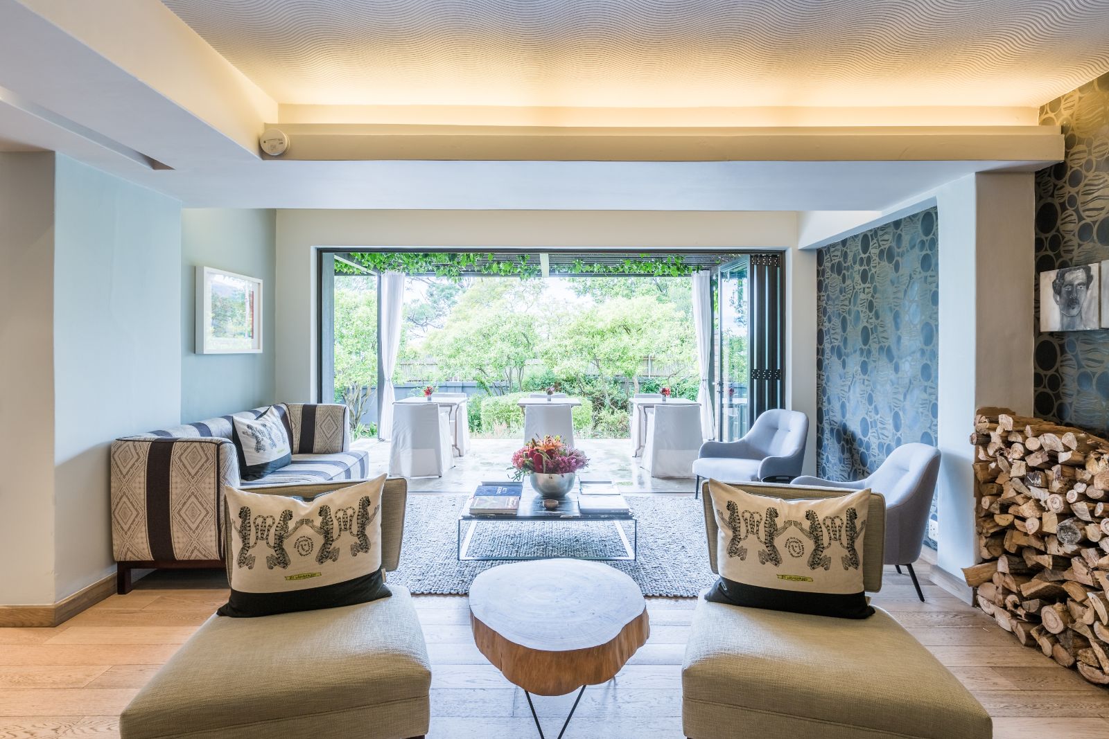 Casual lounge dining terrace with floor to ceiling window folding doors at luxury hotel Kensington Place in Cape Town South Africa