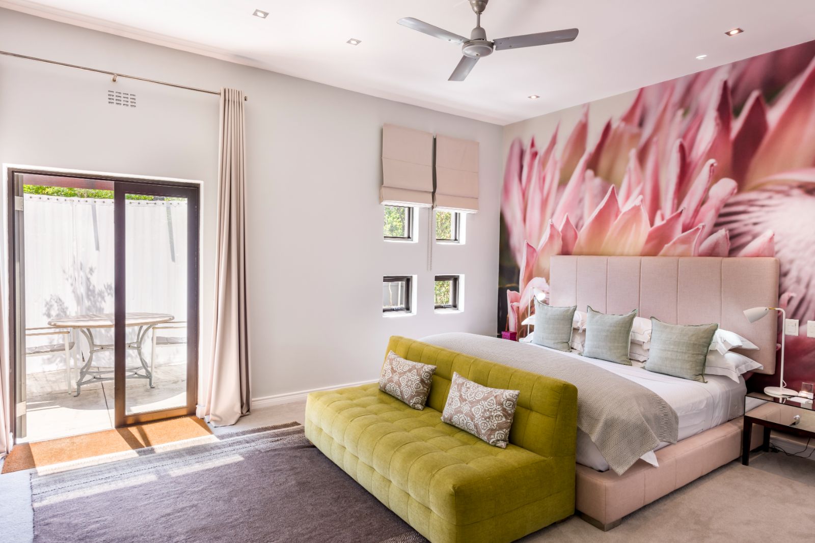 Superior room with pink aesthetic and private outside courtyard at luxury hotel Kensington Place in Cape Town South Africa