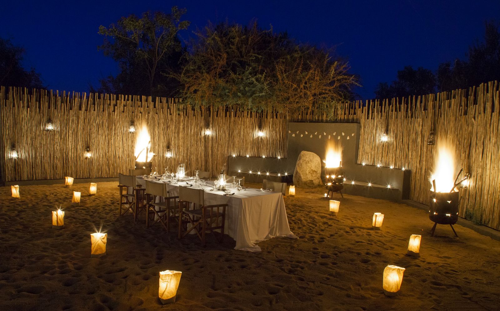 Outdoor dining at night at Londolozi Granite Suites in South Africa