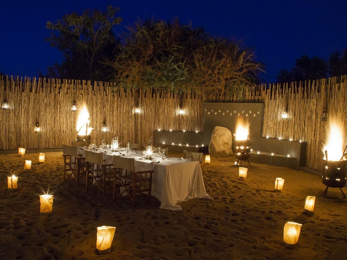 Outdoor dining at night at Londolozi Granite Suites in South Africa