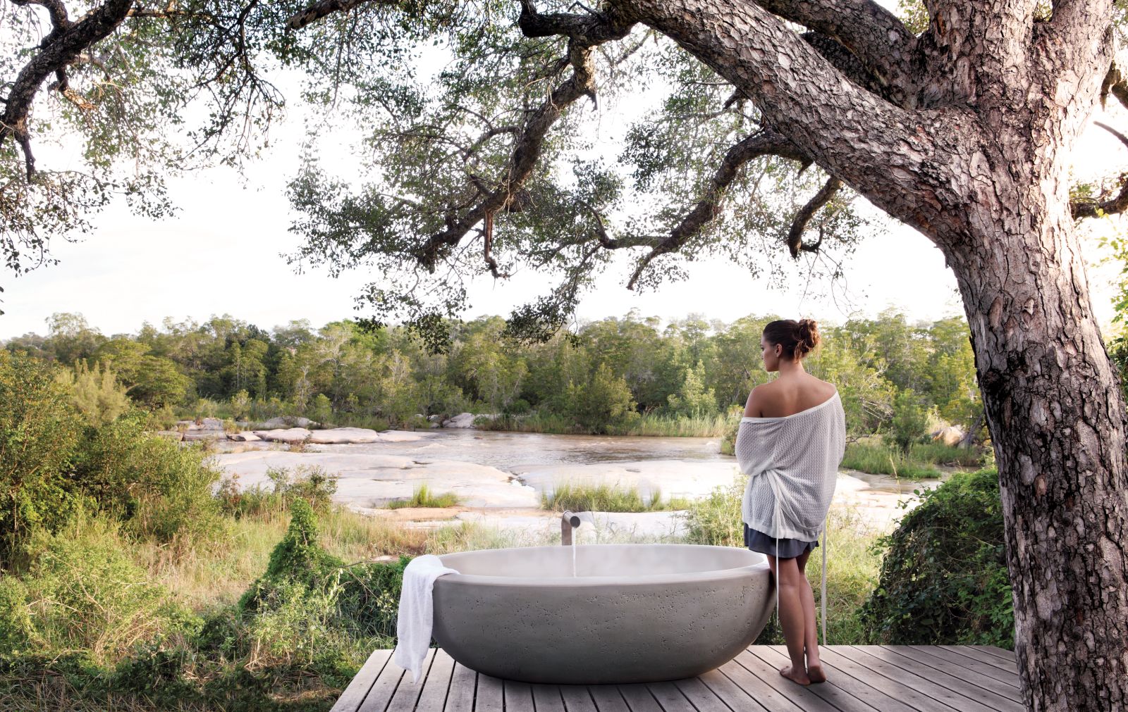 Outdoor bath with river view at Londolozi Granite Suites in South Africa