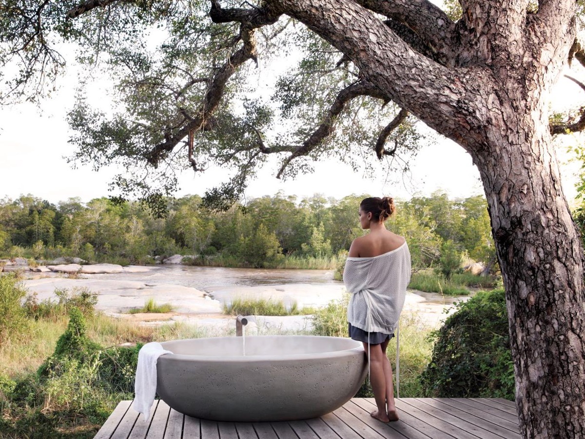 Outdoor bath with river view at Londolozi Granite Suites in South Africa