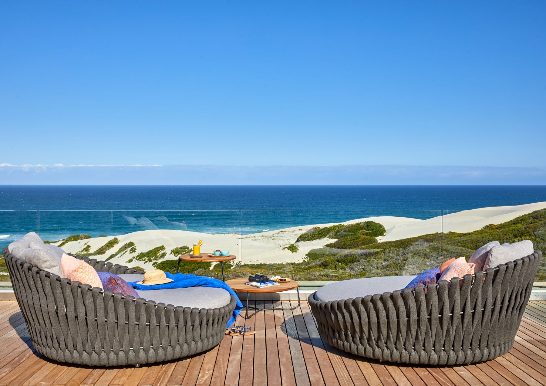 Terrace with chairs overlooking the ocean at Morukuru Beach Lodge in the De Hoop Nature Reserve