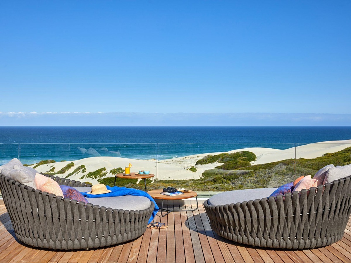 Terrace with chairs overlooking the ocean at Morukuru Beach Lodge in the De Hoop Nature Reserve