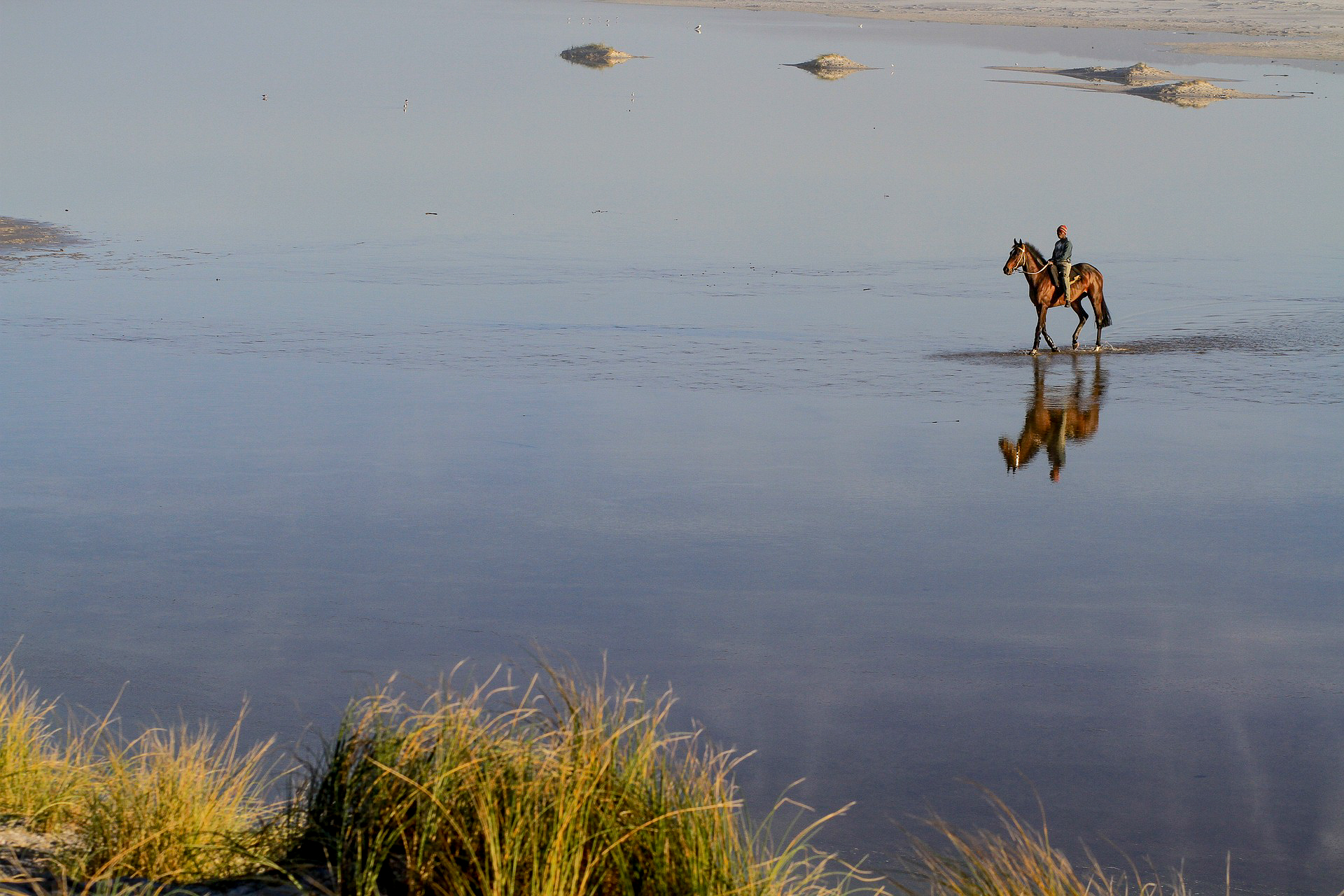 A man riding on Noordhoek Beach in South Africa