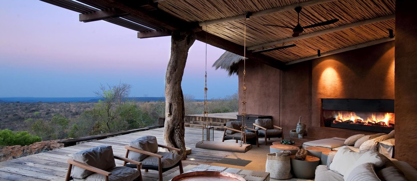 Outdoor covered terrace with fireplace at Leobo the Observatory, South Africa