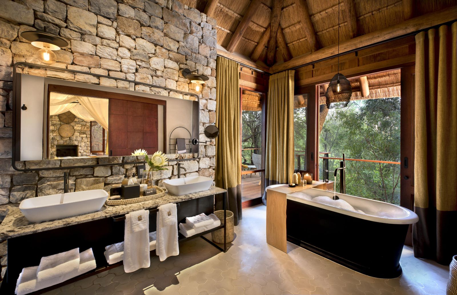 Bathroom with tub overlooking the wilderness at luxury private house Morukuru River House in the Madikwe Game Reserve in South Africa