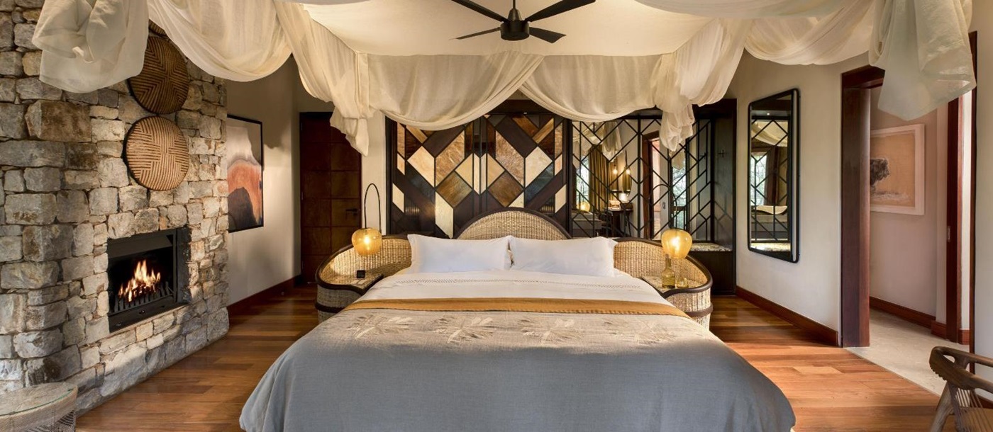 Double bedroom at luxury private house Morukuru River House in the Madikwe Game Reserve in South Africa with art deco and African design influences