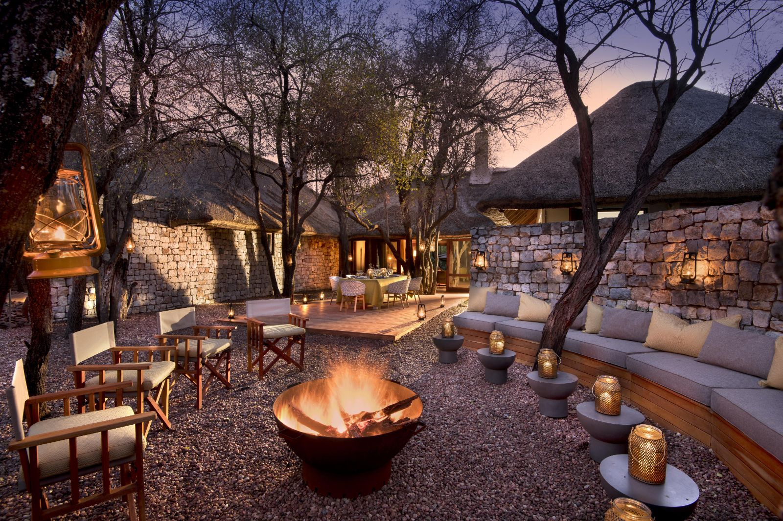 Fireplace and boma for outdoor lounging at luxury private house Morukuru River House in the Madikwe Game Reserve in South Africa